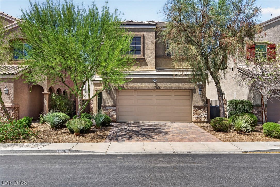 1146 Jesse Harbor Avenue, Henderson, NV 89014 An inviting facade showcases desert landscaping and a brick paver driveway.