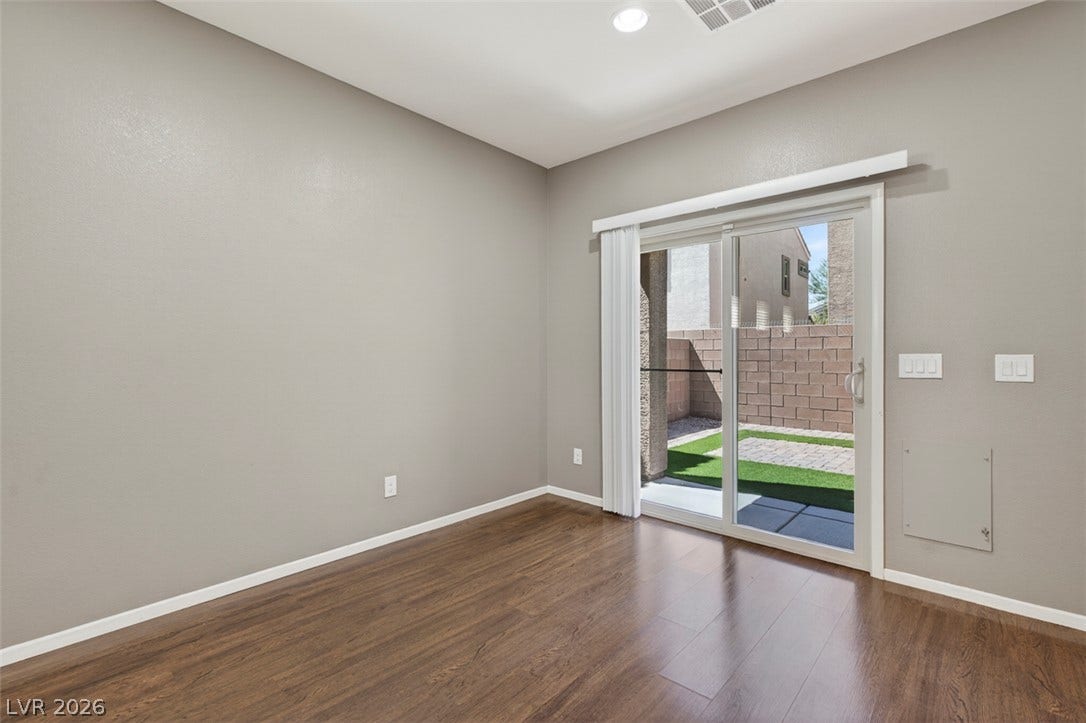 1146 Jesse Harbor Avenue, Henderson, NV 89014 Durable wood-look flooring enhances this versatile room, featuring direct access to a private outdoor space.