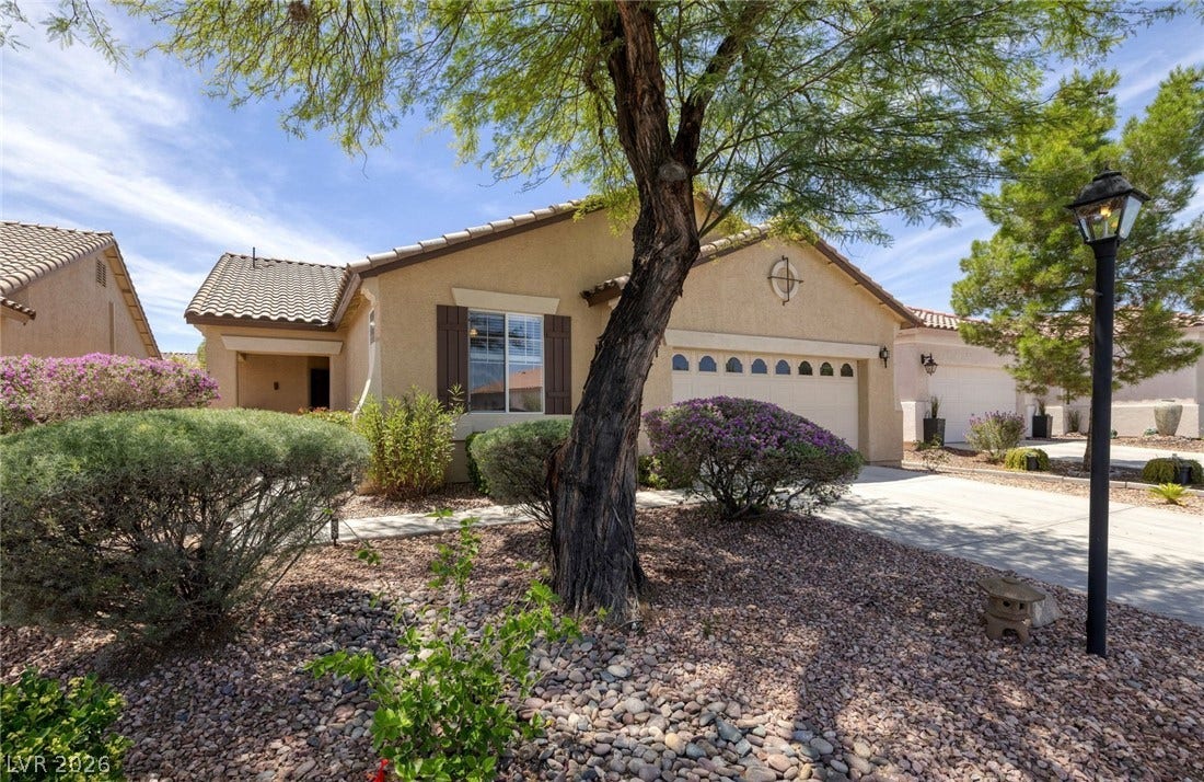4467 Verdiccio Avenue, Las Vegas, NV 89141 A well-kept front yard with mature landscaping enhances this charming single-story residence.