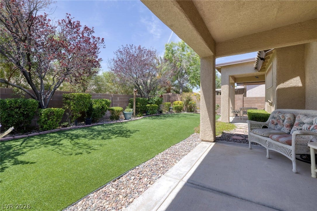 4467 Verdiccio Avenue, Las Vegas, NV 89141 A private, low-maintenance yard features artificial turf, mature landscaping, and a covered patio for outdoor enjoyment.