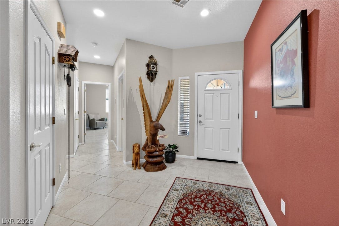 4467 Verdiccio Avenue, Las Vegas, NV 89141 A well-lit entry hall with tile flooring and a view into the living areas beyond.