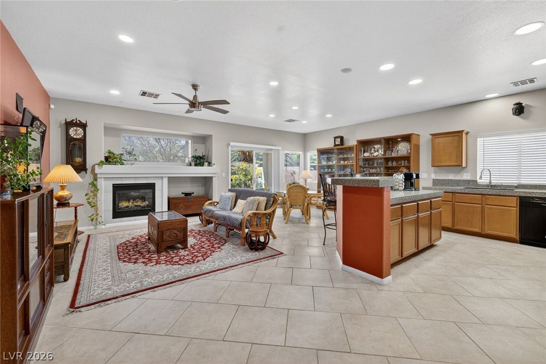 4467 Verdiccio Avenue, Las Vegas, NV 89141 Enter into an inviting open-concept living area with a cozy fireplace and seamless flow into the kitchen.