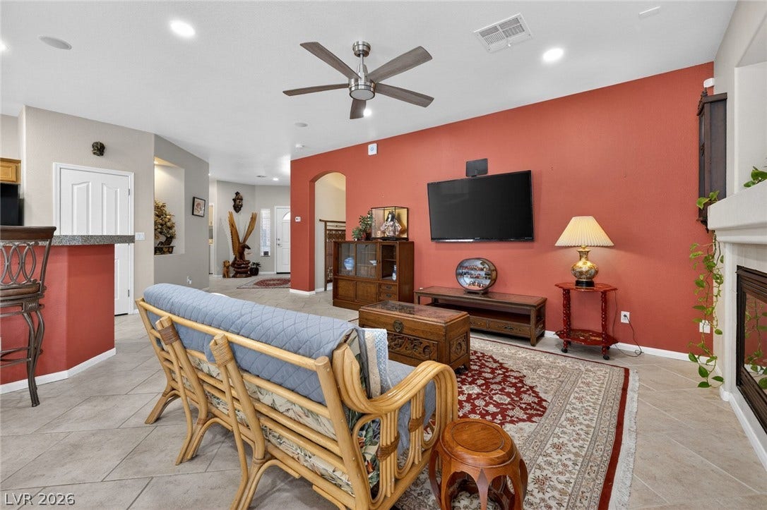 4467 Verdiccio Avenue, Las Vegas, NV 89141 A terracotta accent wall provides a warm focal point in this inviting living space.