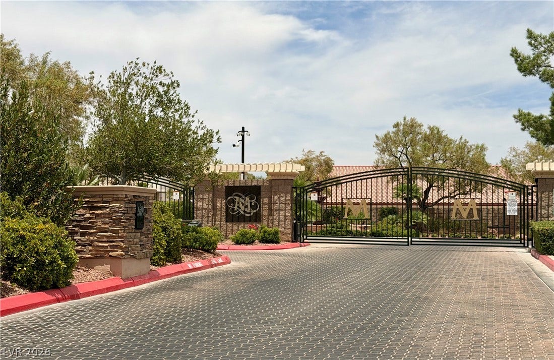 4467 Verdiccio Avenue, Las Vegas, NV 89141 Secure Montecito community entrance with an elegant wrought iron gate and decorative stone pillars.