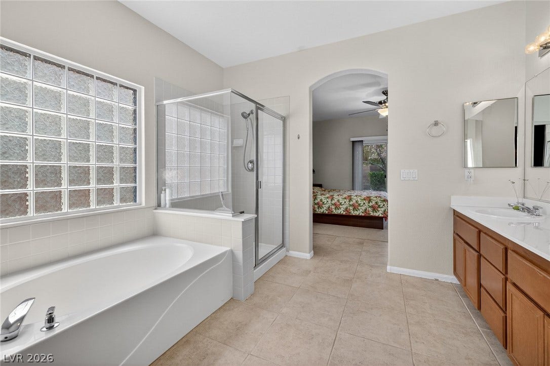 4467 Verdiccio Avenue, Las Vegas, NV 89141 Indulge in relaxation with a spacious soaking tub and a separate glass-enclosed shower.