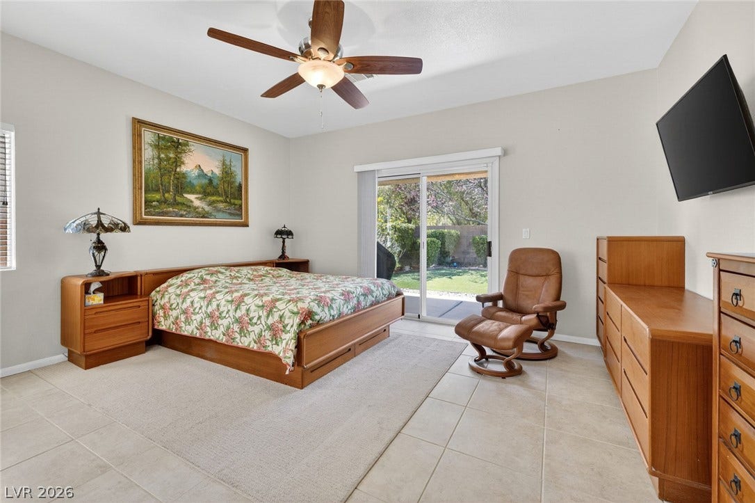 4467 Verdiccio Avenue, Las Vegas, NV 89141 The Primary bedroom features access to the backyard patio, a ceiling fan and tile flooring.