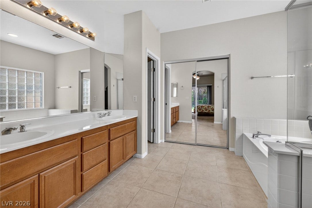 4467 Verdiccio Avenue, Las Vegas, NV 89141 Dual vanities and walk-in closet with mirrored sliding doors.