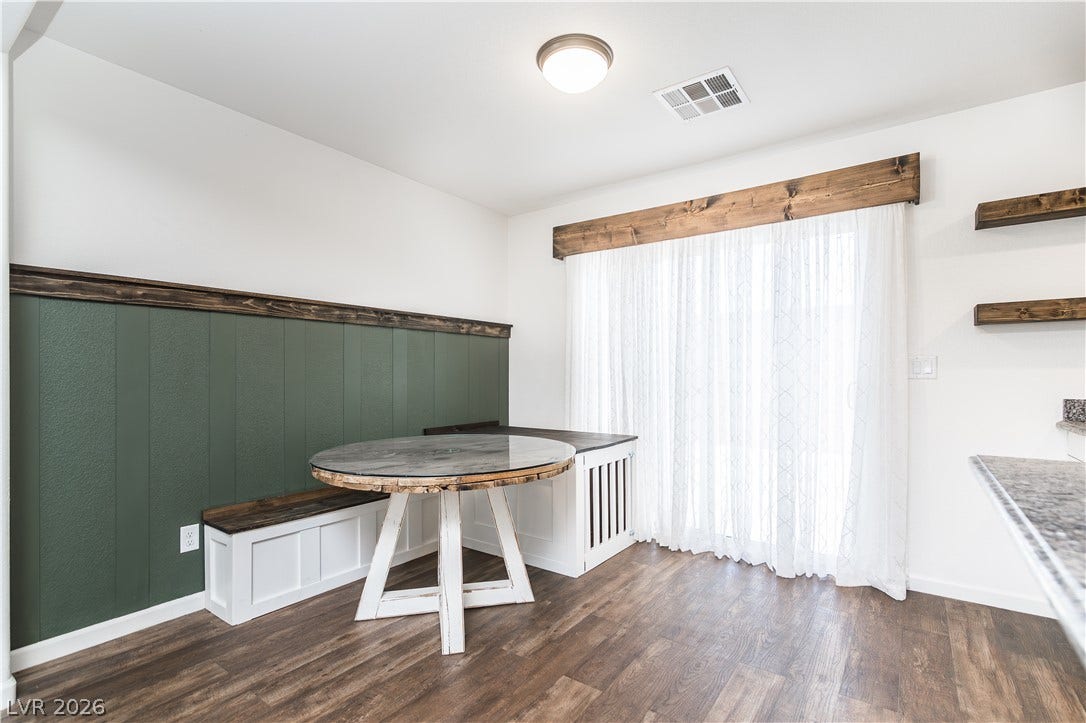 989 Harbor Avenue, Henderson, NV 89002 Built-in banquette seating with a custom wood table and rich wood-paneled walls define this cozy dining area.