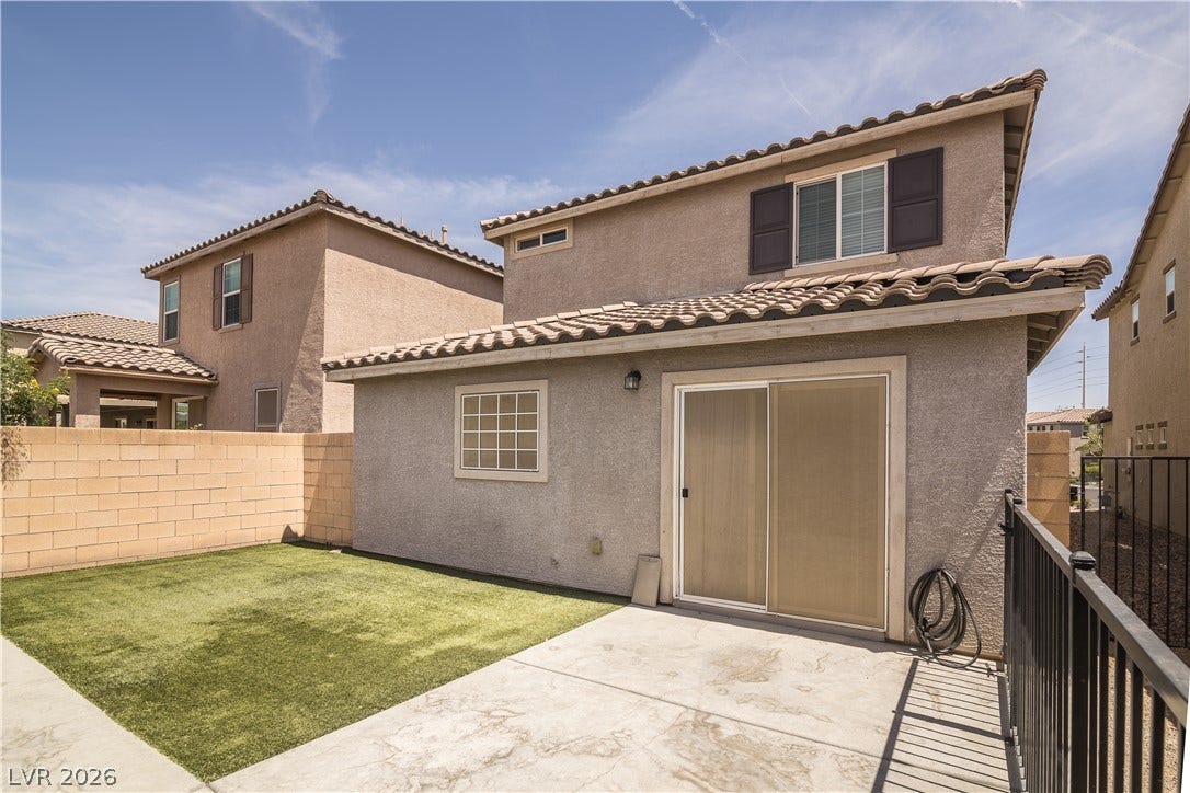 989 Harbor Avenue, Henderson, NV 89002 Backyard with artificial turf and a concrete patio provides a low-maintenance outdoor area.