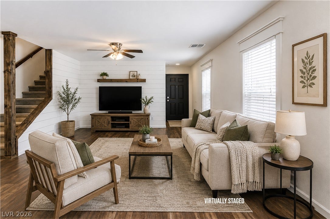 989 Harbor Avenue, Henderson, NV 89002 A welcoming living area boasts wood like floors and a striking wood accent staircase.