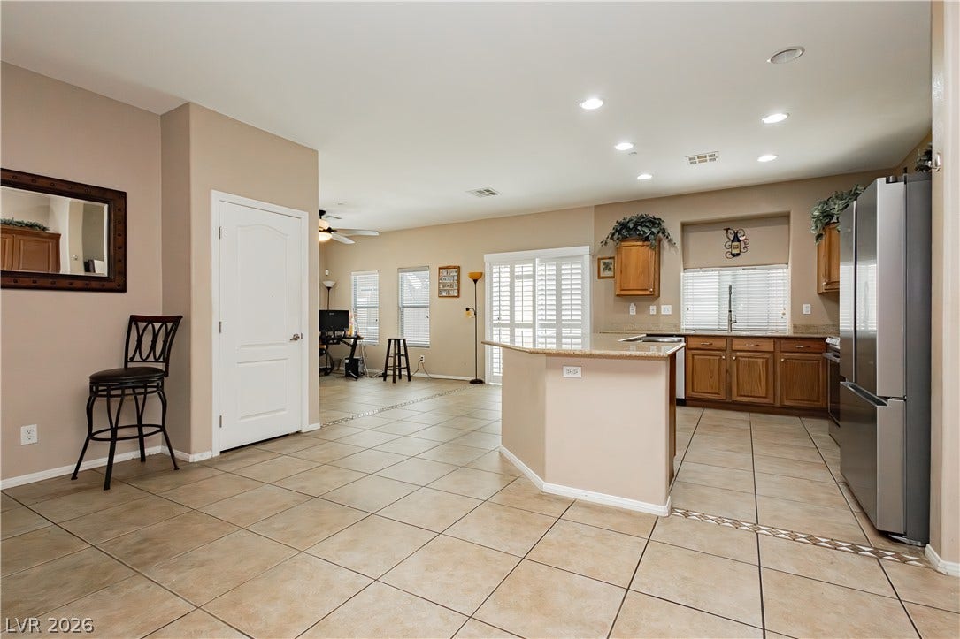 1176 Via Piazza, Henderson, NV 89052 A harmonious open-concept living space with sleek tile flooring and a functional kitchen.