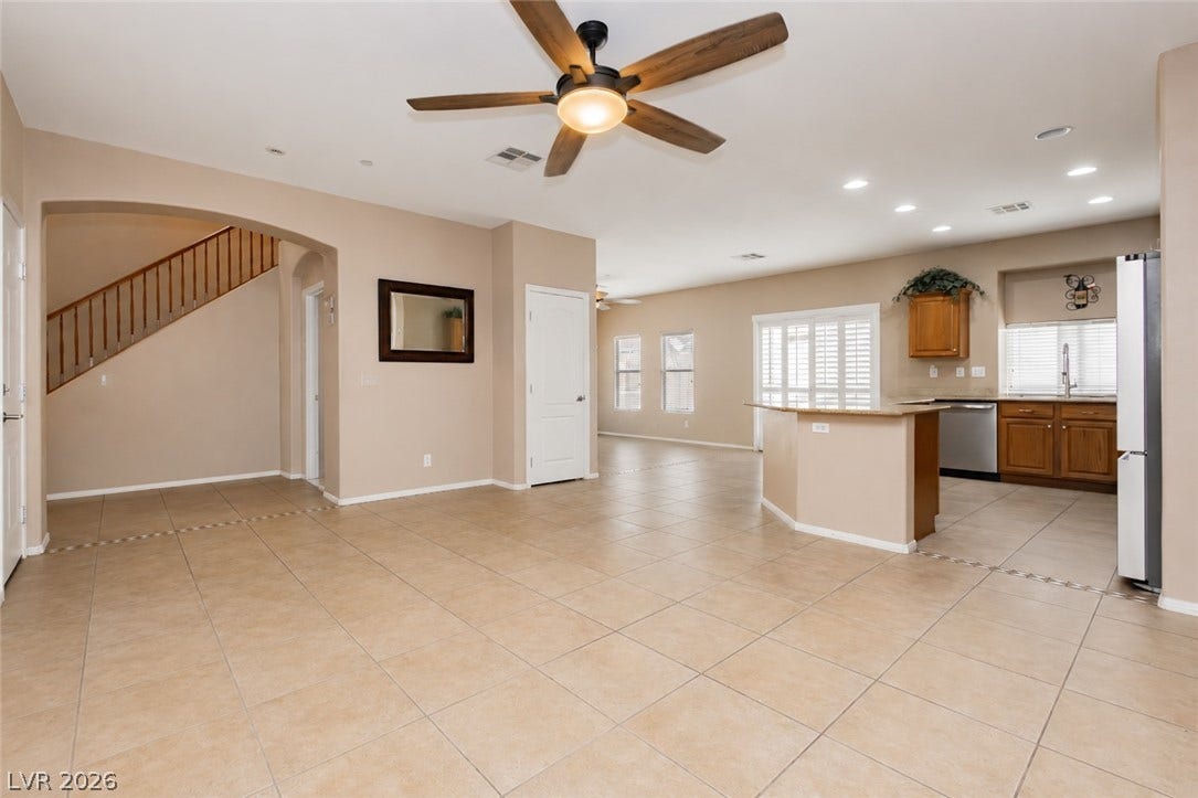 1176 Via Piazza, Henderson, NV 89052 An inviting open-concept living area with a functional kitchen island and warm tile flooring.