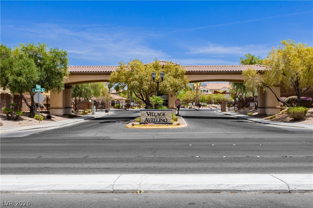 1176 Via Piazza, Henderson, NV 89052 Secure community entrance with an arched gate beckons residents home.