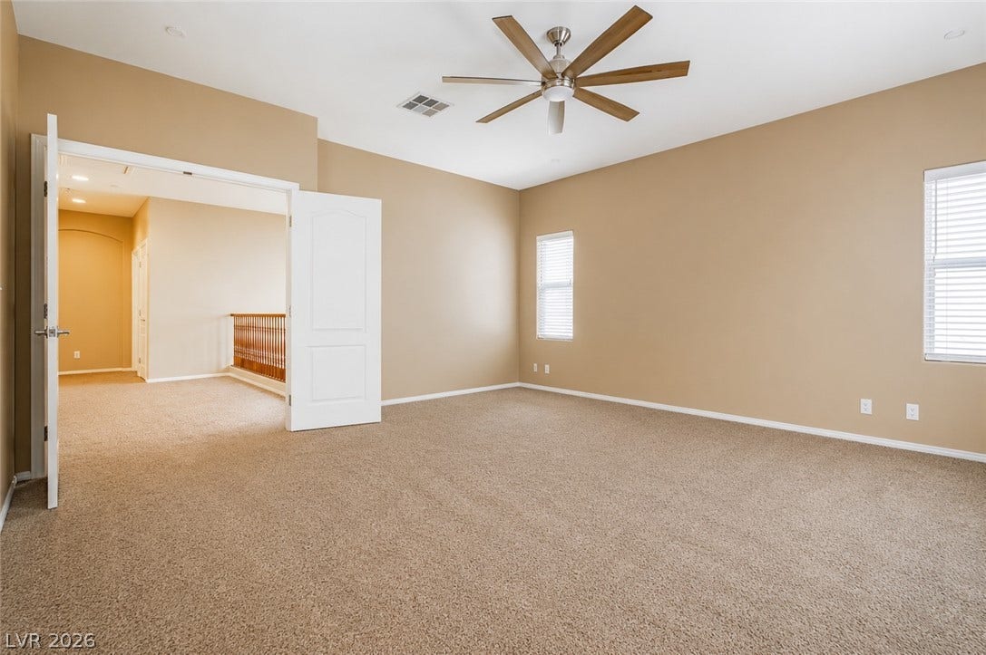 1176 Via Piazza, Henderson, NV 89052 A spacious room offers ample natural light and plush carpeting, ready for your personalized touch.