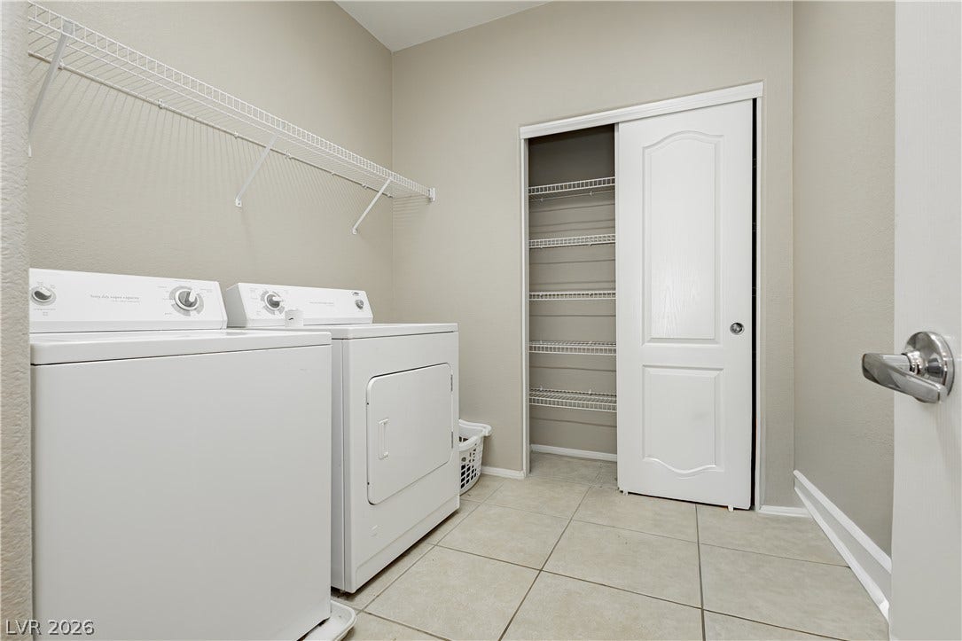 1176 Via Piazza, Henderson, NV 89052 Functional laundry room offers convenient appliances and built-in shelving.