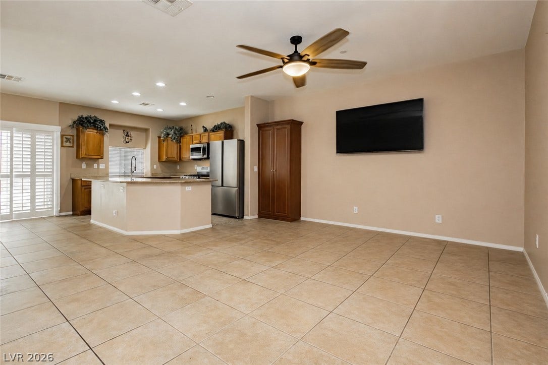 1176 Via Piazza, Henderson, NV 89052 An open-concept living area flows seamlessly into a well-appointed kitchen, all under high ceilings with recessed lighting.