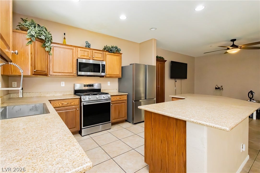 1176 Via Piazza, Henderson, NV 89052 A well-equipped culinary space featuring an island with ample counter space and convenient appliances.