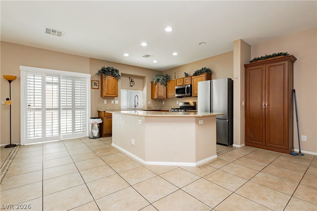 1176 Via Piazza, Henderson, NV 89052 A functional kitchen, featuring an inviting island, offers ample space for meal preparation and entertaining.