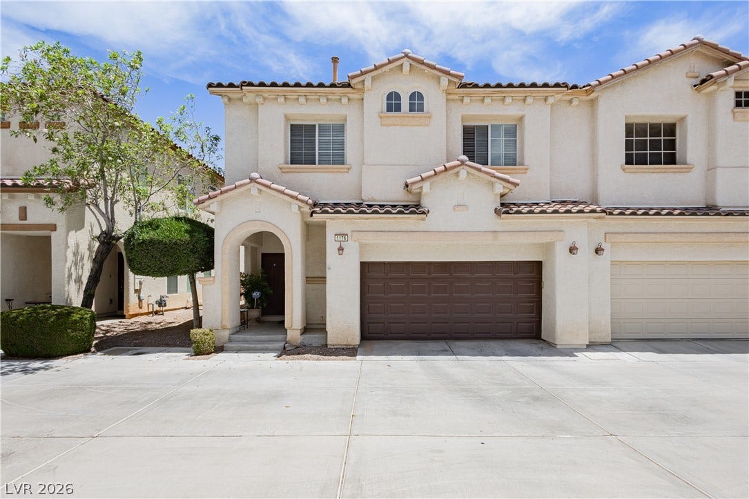 1176 Via Piazza, Henderson, NV 89052 A traditional stucco exterior with arched entry and brown garage door welcomes you home.