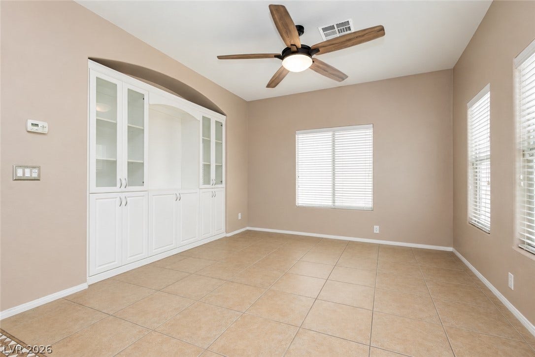 1176 Via Piazza, Henderson, NV 89052 Built-in shelving and cabinets provide ample storage in this well-lit, neutral-toned space.