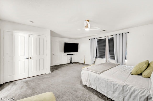 2553 Hummingbird Hill Avenue, Henderson, NV 89074 The carpeted bedroom features a modern ceiling fan, offering a comfortable and serene retreat.