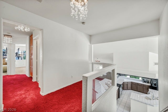 2553 Hummingbird Hill Avenue, Henderson, NV 89074 Bright interior spaces with high ceilings and a distinctive overhead light fixture.