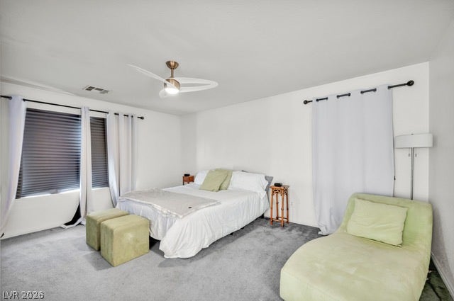 2553 Hummingbird Hill Avenue, Henderson, NV 89074 Well-lit and tranquil, this bedroom features a comfortable bed and seating area, creating a serene personal retreat.