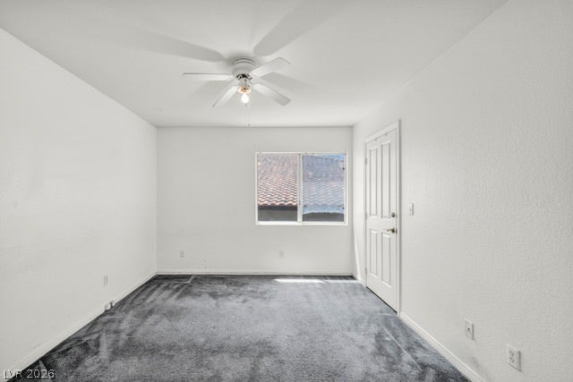 2553 Hummingbird Hill Avenue, Henderson, NV 89074 A well-lit bedroom features plush carpeting and a convenient ceiling fan for optimal comfort.