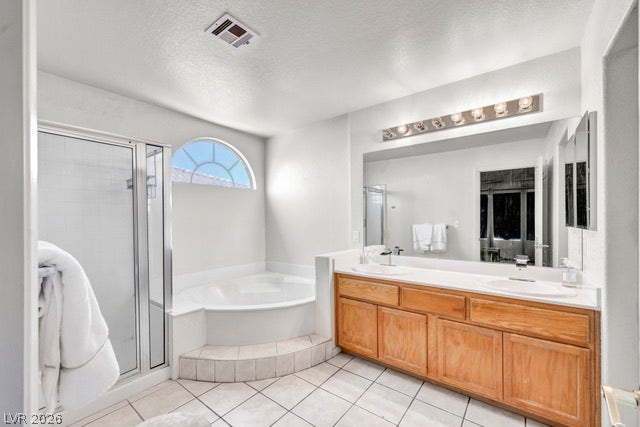 2553 Hummingbird Hill Avenue, Henderson, NV 89074 Relax in this tranquil bathroom featuring a corner tub and a spacious double vanity.