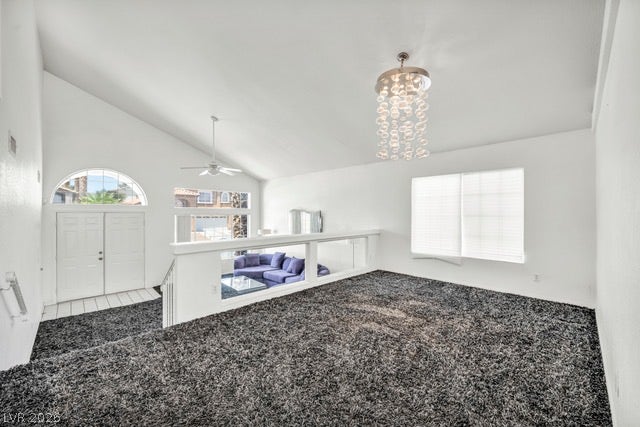 2553 Hummingbird Hill Avenue, Henderson, NV 89074 A spacious upper-level area offers views into the primary living space, featuring high ceilings and a chic chandelier.