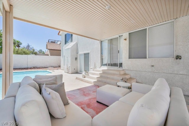 2553 Hummingbird Hill Avenue, Henderson, NV 89074 An inviting covered patio overlooking a refreshing pool, perfect for outdoor leisure.
