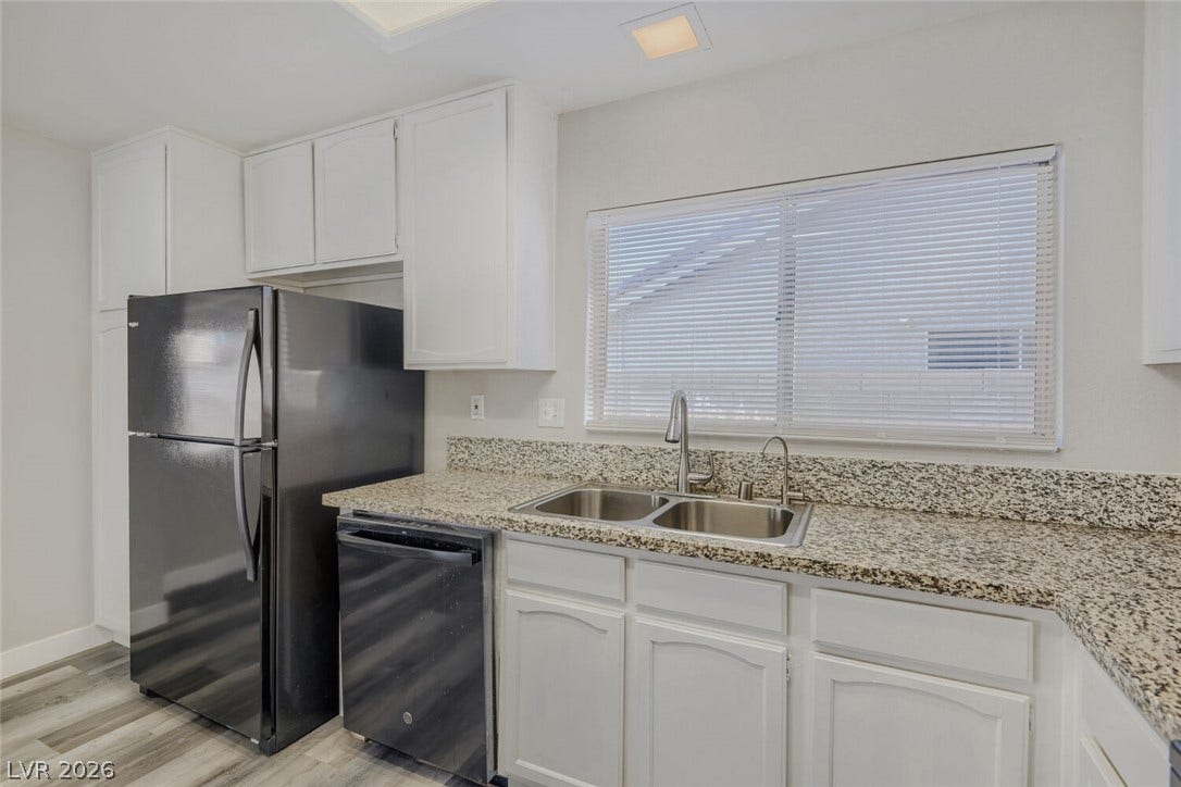 2343 Valleywood Road, Henderson, NV 89014 Functional kitchen with ample cabinetry and speckled countertops, perfect for daily routines.