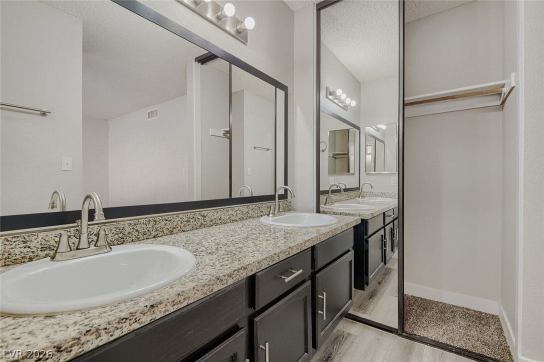 2343 Valleywood Road, Henderson, NV 89014 Double vanities with sleek granite counters complete this well-appointed bath.