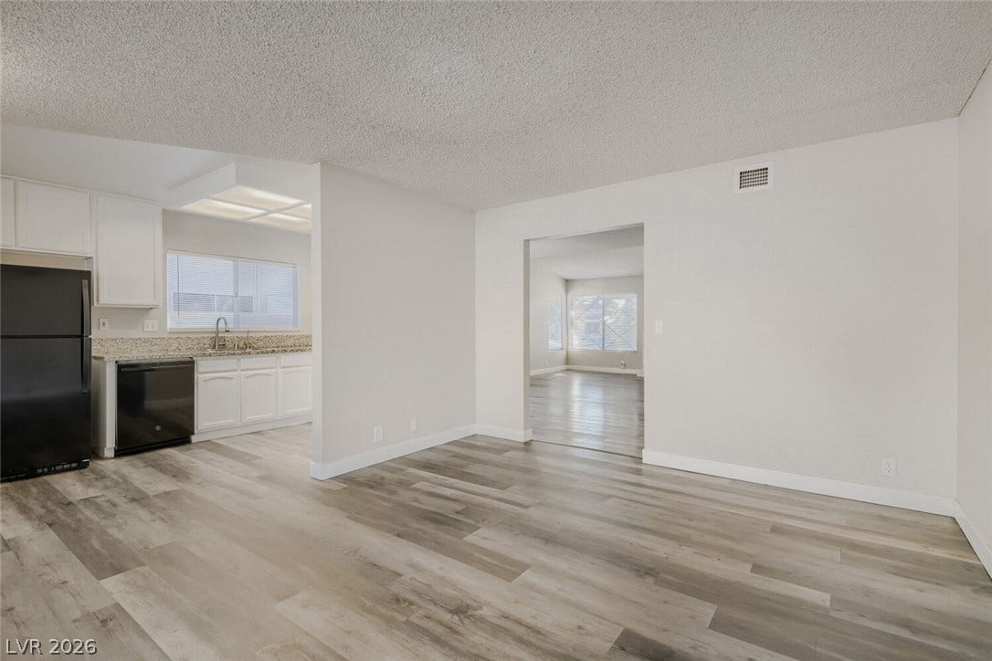 2343 Valleywood Road, Henderson, NV 89014 Discover open-concept living with sleek hardwood flooring connecting the kitchen and common areas.