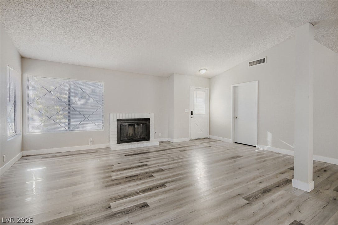 2343 Valleywood Road, Henderson, NV 89014 A generous living space featuring an inviting fireplace and easy-care laminate flooring.