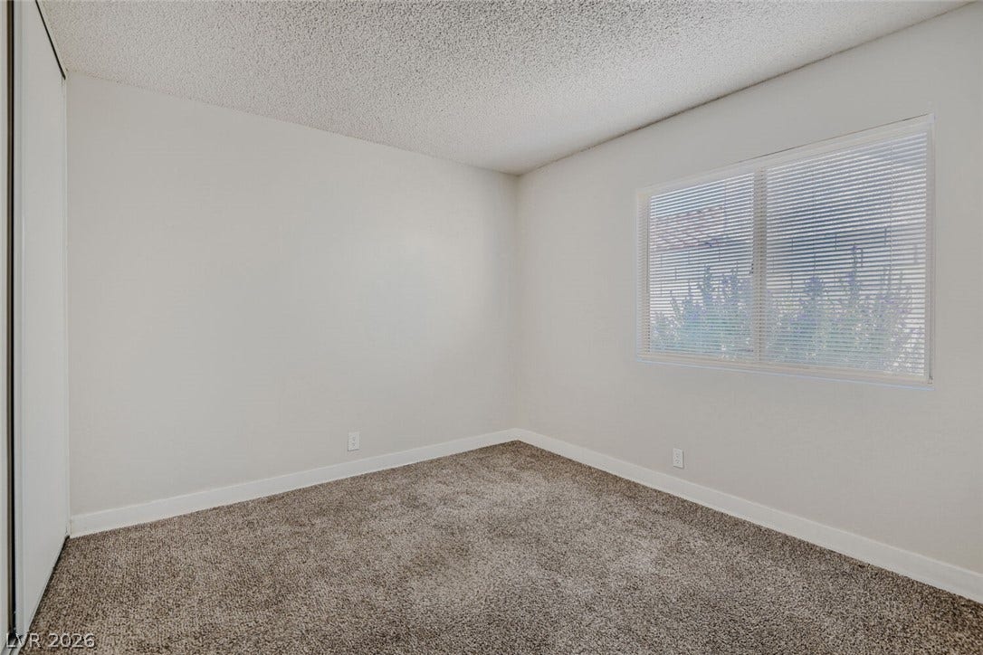 2343 Valleywood Road, Henderson, NV 89014 A well-lit bedroom with fresh carpeting awaits your personal touch.