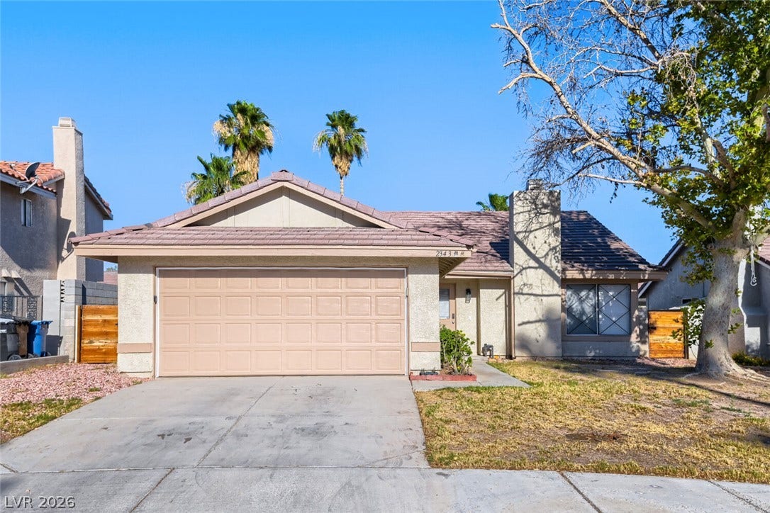 2343 Valleywood Road, Henderson, NV 89014 A well-maintained facade with an attached garage and a mature shade tree graces this charming residence.