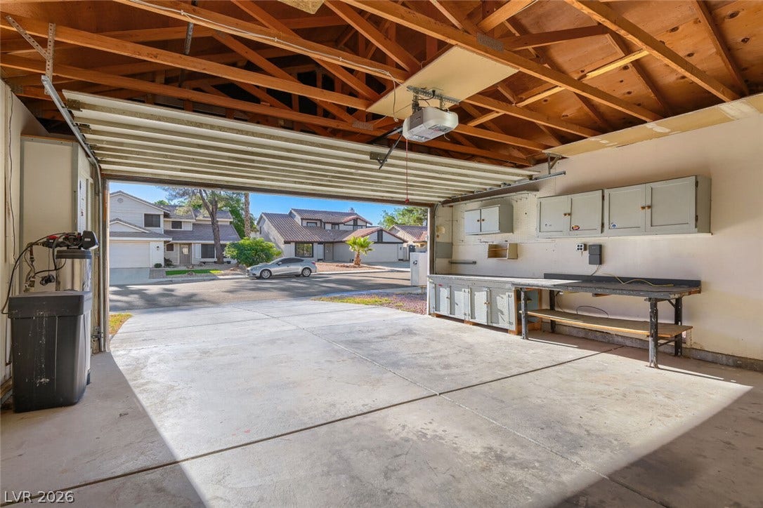 2343 Valleywood Road, Henderson, NV 89014 A spacious garage features a work area and ample storage, providing both utility and direct neighborhood views.