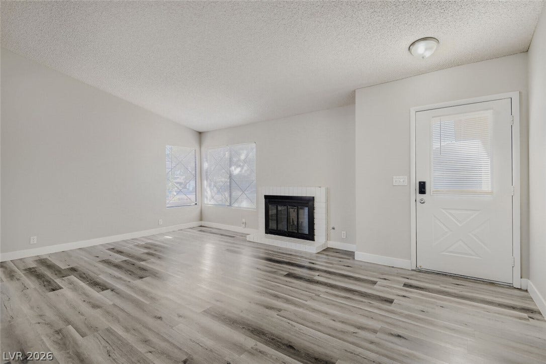 2343 Valleywood Road, Henderson, NV 89014 Luminous living area features attractive flooring and a charming corner fireplace.