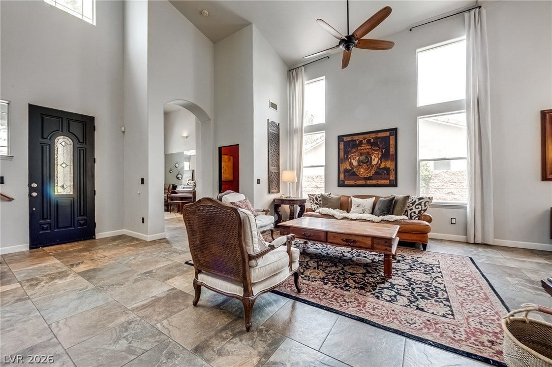 2393 Stansbury Court, Henderson, NV 89052 A grand entrance with high ceilings and large windows illuminates this inviting living space.