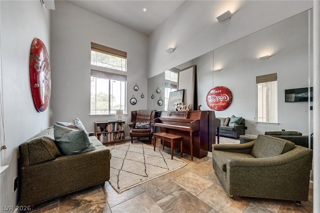 2393 Stansbury Court, Henderson, NV 89052 A versatile living area with a piano, high ceilings, and tiled flooring.