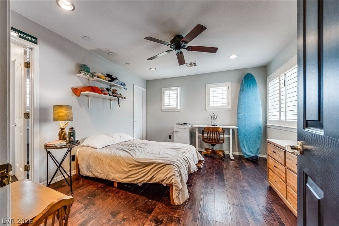 2393 Stansbury Court, Henderson, NV 89052 Rich hardwood floors complement a bedroom complete with recessed lighting and a ceiling fan for comfort.
