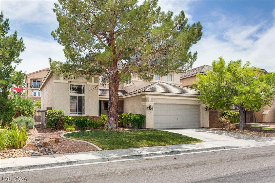 2393 Stansbury Court, Henderson, NV 89052 A graceful home with mature trees, a driveway, and an attached garage.