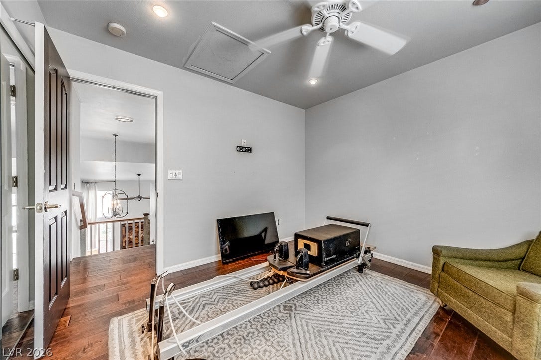 2393 Stansbury Court, Henderson, NV 89052 A versatile bonus space features wood flooring and a refreshing ceiling fan, perfect for a home gym.