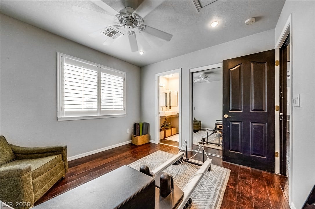 2393 Stansbury Court, Henderson, NV 89052 Hardwood floors and a ceiling fan create a comfortable atmosphere in this flexible space, perfect for a home gym.
