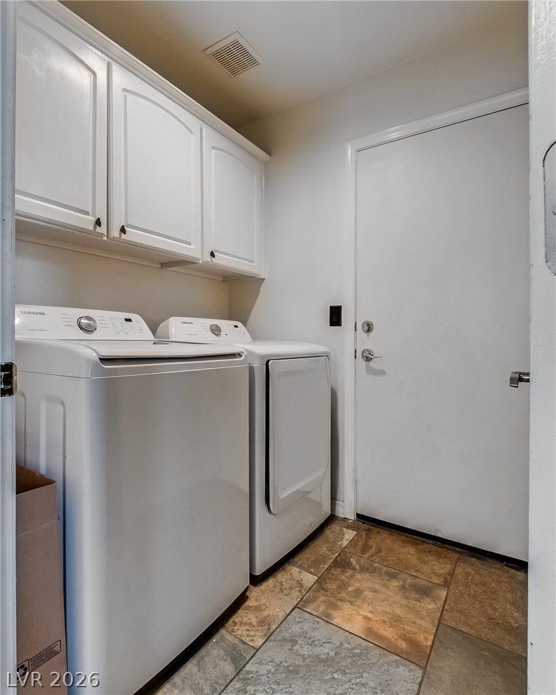 2393 Stansbury Court, Henderson, NV 89052 Tiled flooring and bright cabinetry define this well-appointed laundry space.