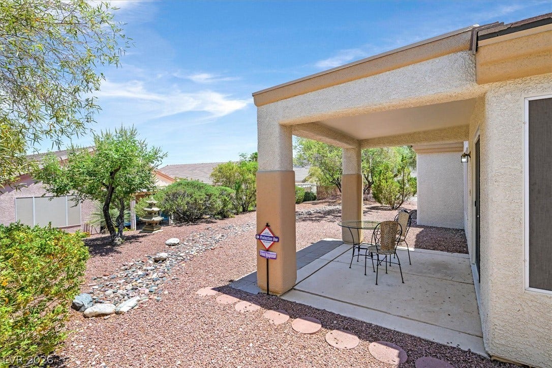468 Bonnie Brook Place, Henderson, NV 89012 An inviting covered patio area offers a cool retreat amidst low-maintenance landscaping.