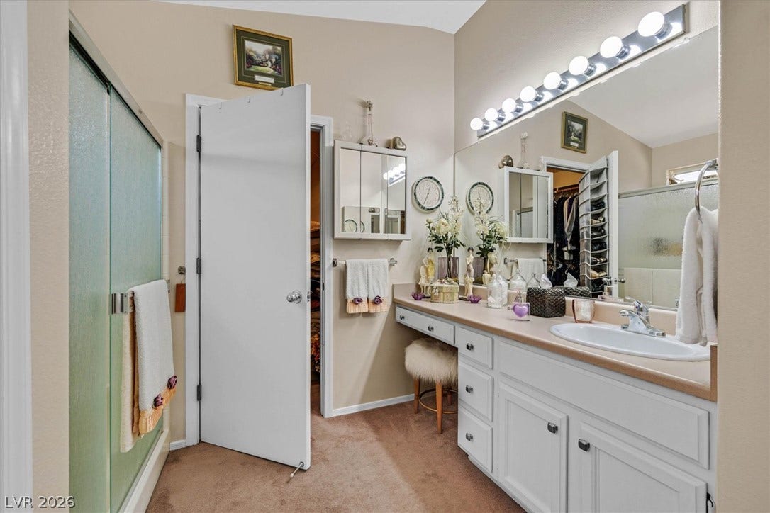 468 Bonnie Brook Place, Henderson, NV 89012 A well-appointed primary bathroom features a spacious vanity with ample counter space and a full-sized mirror.