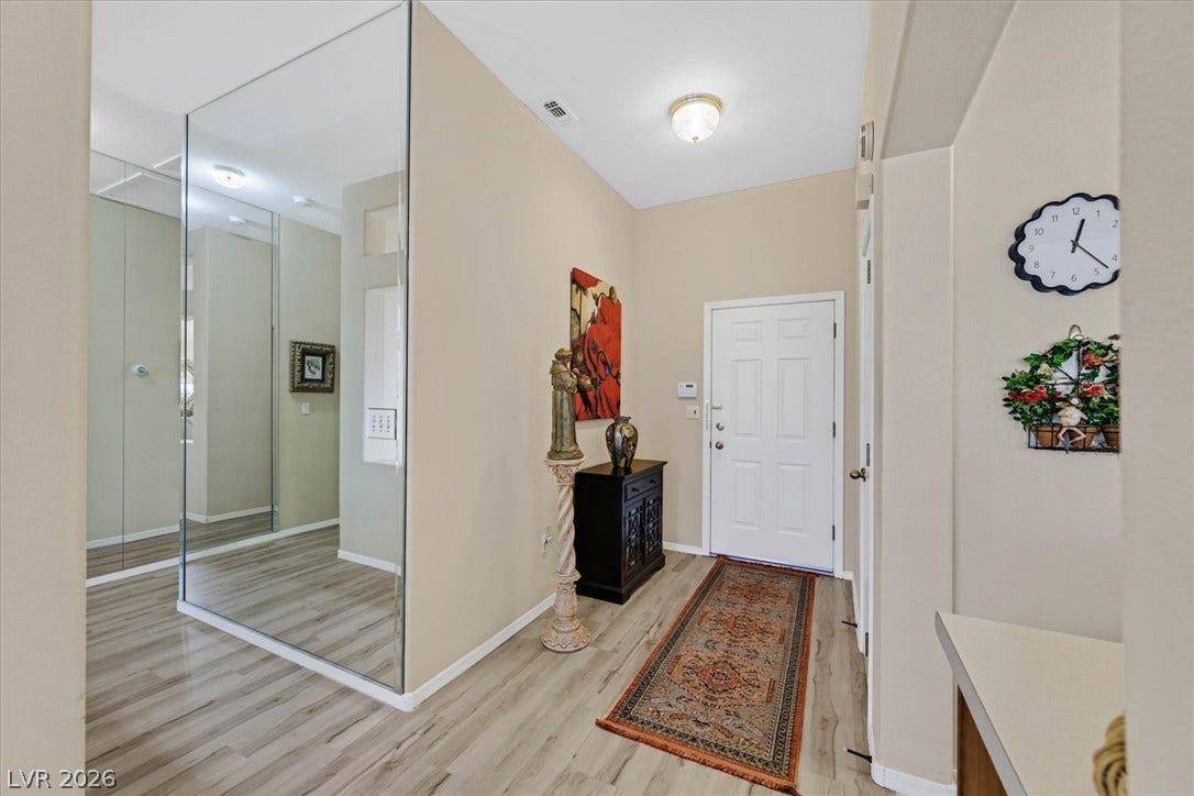 468 Bonnie Brook Place, Henderson, NV 89012 Step into this welcoming entrance foyer featuring light wood-look flooring and a classic white paneled door.