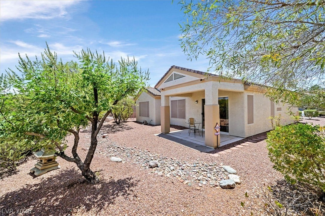 468 Bonnie Brook Place, Henderson, NV 89012 A tranquil desert landscape surrounds this inviting back patio, offering a private outdoor retreat.